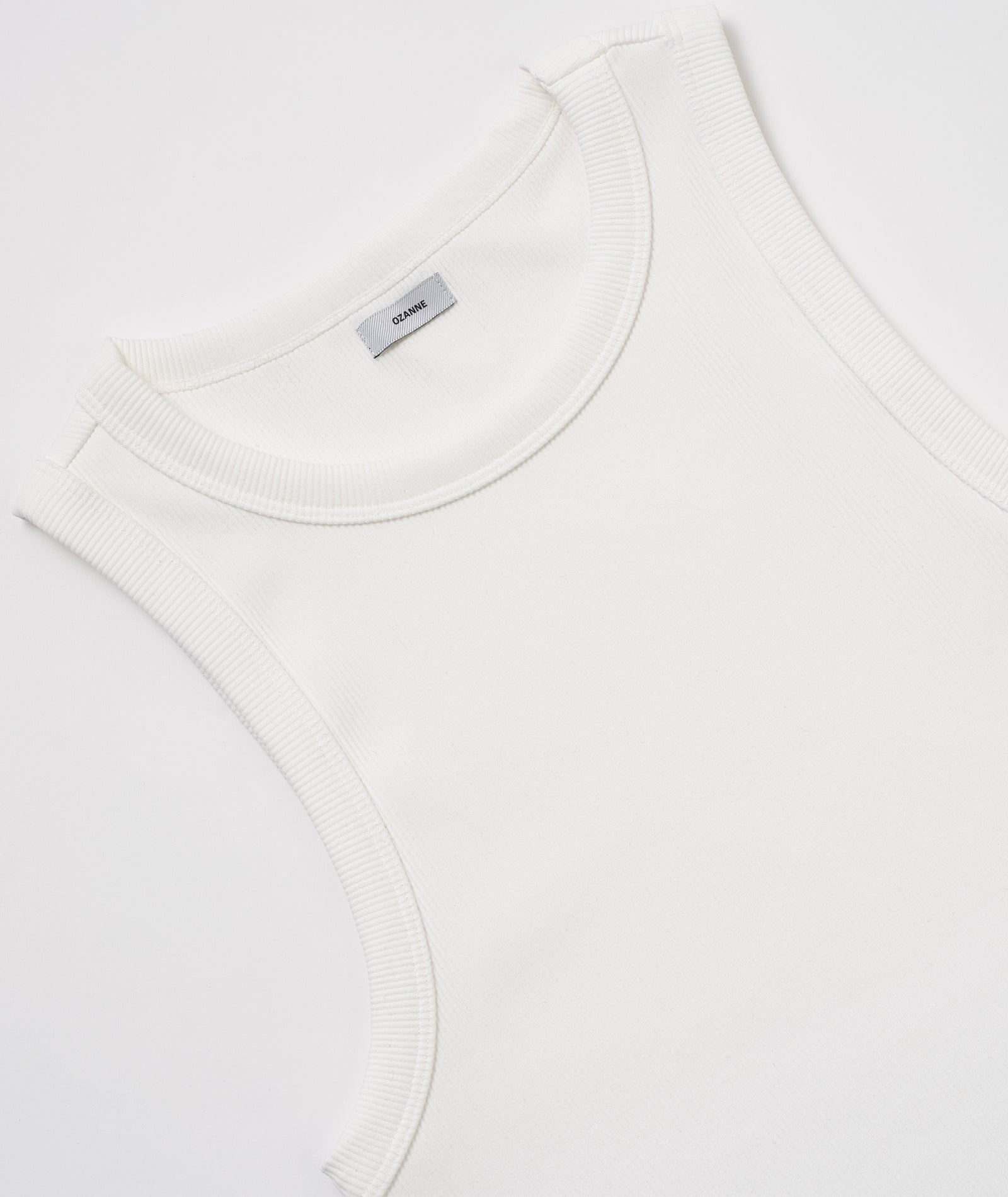 A white sleeveless top or tank top is shown in the image.